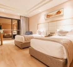 Premium hotel room interior with twin beds and modern amenities